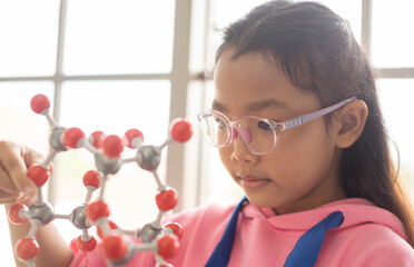 STEM education concept. Asian children in laboratory research an experiment exam with molecule model. The new education system in a classroom include Science, Technology, Engineering and Mathematics.