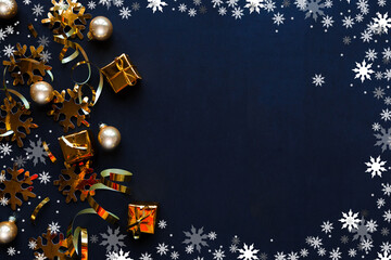 Golden decorations on black background. Flat lay, top view, copy space. Merry Christmas and Happy New Year