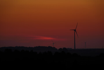 Obraz premium WIND FARM AND SUN - A sunny and hot morning and renewable energy sources 