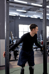 Fototapeta na wymiar young awesome man having fun at gym. smiling man gets pleasure from workout, happiness, love of life