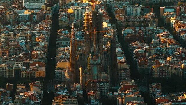 Aerial Shot of Bas&iacute;lica i Temple Expiatori de la Sagrada Fam&iacute;lia At Sunset. Avinguda de Gaud&iacute;, beautiful panorama. European cityscape. Mediterranean city. Aerial establishing shot of Barcelona. 