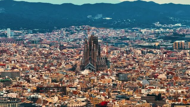 Aerial Shot of Bas&iacute;lica i Temple Expiatori de la Sagrada Fam&iacute;lia At Sunset. Avinguda de Gaud&iacute;, beautiful panorama. European cityscape. Mediterranean city. Aerial establishing shot of Barcelona. 