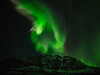 Naklejka na ściany i meble The aurora borealis or northern lights over the mountains of the central Brooks Range, Alaska, USA.