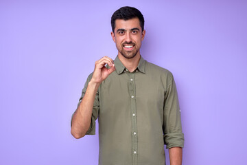 cheerful brunette bearded man demonstrating the letter o . sign language symbol for deaf human in blue background. isolated © alfa27