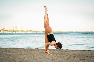 Fototapeta na wymiar Yoga Teacher Demonstrating Asanas During a Lakeside Retreat Tour