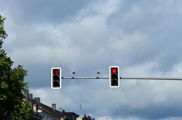 A traffic light hangs on a pole in Europe