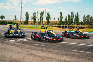 three racing go karts on a race track