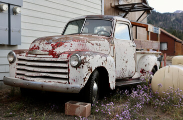 old abandoned pickup truck in a dirt lot