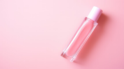 Top view on Lipgloss glass bottle isolated on flat pastel pink background with copy space. 