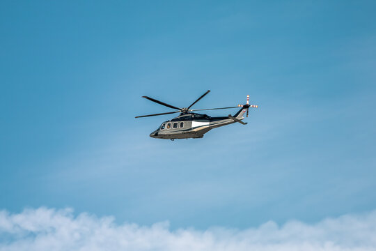 helicopter AgustaWestland AW139 flying in blue sky