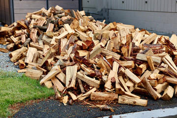 huge pile of split logs for firewood