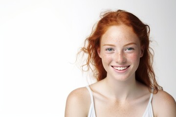 Close up portrait of an attractive excited young woman with long red hair standing isolated over white background, grimacing