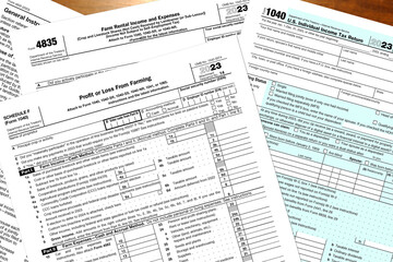 2023 IRS tax forms lay on a desk.