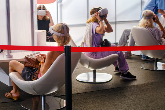 Unidentified people in virtual reality headset testing new VR experience.