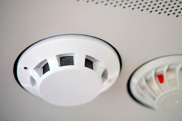 Smoke detector in the train, close up. Fire alarm system on a white ceiling, close up of smoke detector