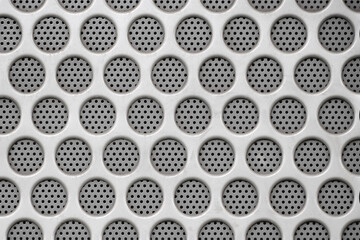 Background of a white perforated speaker panel with holes.