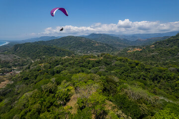 Aerial View of extreme paragliding sport in the Beautiful beach in Dominical - Costa Rica 