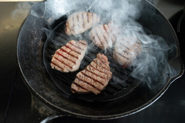 Cook a beef fillet steak on a cast iron pan.