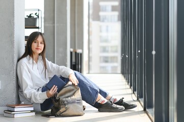 education and school concept - student girl studying and reading book at school.