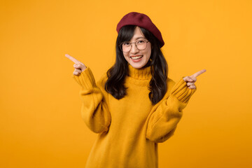Stylish young woman in a red beret and yellow sweater against a vibrant yellow background, showcasing a fashion choice. - obrazy, fototapety, plakaty