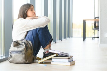 Lonely sad schoolgirl while all her classmates ignored her. Social exclusion problem. Bullying at school concept.