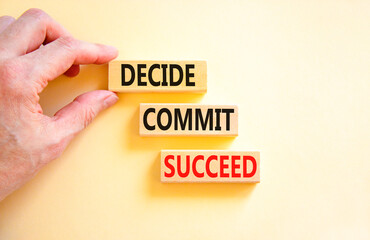 Decide commit succeed symbol. Concept word Decide Commit Succeed on beautiful wooden block. Businessman hand. Beautiful white table background. Business decide commit succeed concept. Copy space.