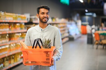 portrait of indian male in grocery with positive attitude