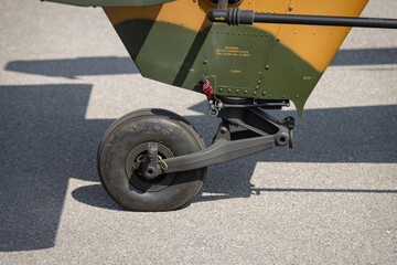 Detail of a landing gear and chassis of a parked combat helicopter on apron.