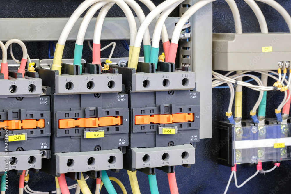 Poster close-up of electricity distribution box with wires and circuit breakers in control room.