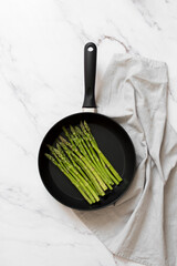 Frying pan with asparagus studio product photography 