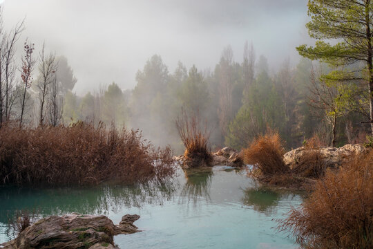 Foggy landscape at dawn in one of the ponds of the Chorreras del Río Cabriel in Enguídanos, Cuenca, Spain