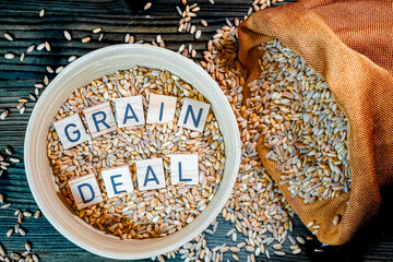 Wheat grains with in jute bag and cup with letters Ukraine grain crisis, global crisis concept due to war