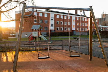 Two swings on a modern playground in Europe, Sweden. Typical playground in a residential area. 