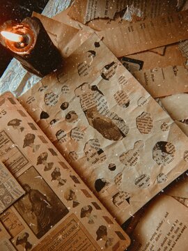 Vintage Aesthetic Scrapbook On A Table And A Red Candle