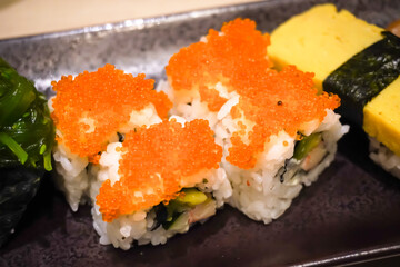 Various sushi platter in square ceramic plate on Japanese Restaurant. Concept for whole healthy food, nutrition, omega-3, animal protein, seafood, modern resto and street food. 