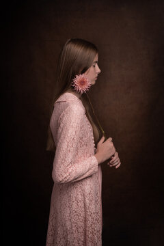 romantic renaissance portrait of woman in pink dress with flower