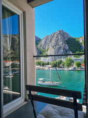 Balcony view with panorama to Emerald-green Cetina River with yachts and rocks in view, Omis, Dalmatia,  Omis riviera, Croatia