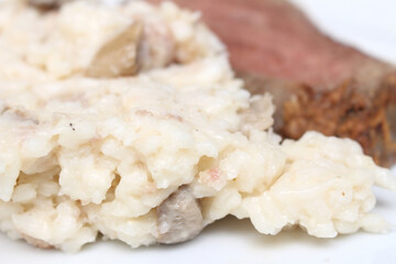 close up of rice. risotto with red meat. rice with meat in the background. risotto with selective focus.