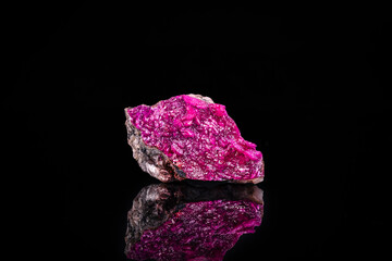 Pink cobalt-bearing dolomite isolated on black background. macro detail close-up rough raw...