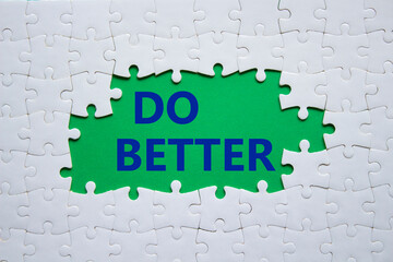 Do better symbol. White puzzle with words Do better. Beautiful green background. Business and Do better concept. Copy space.