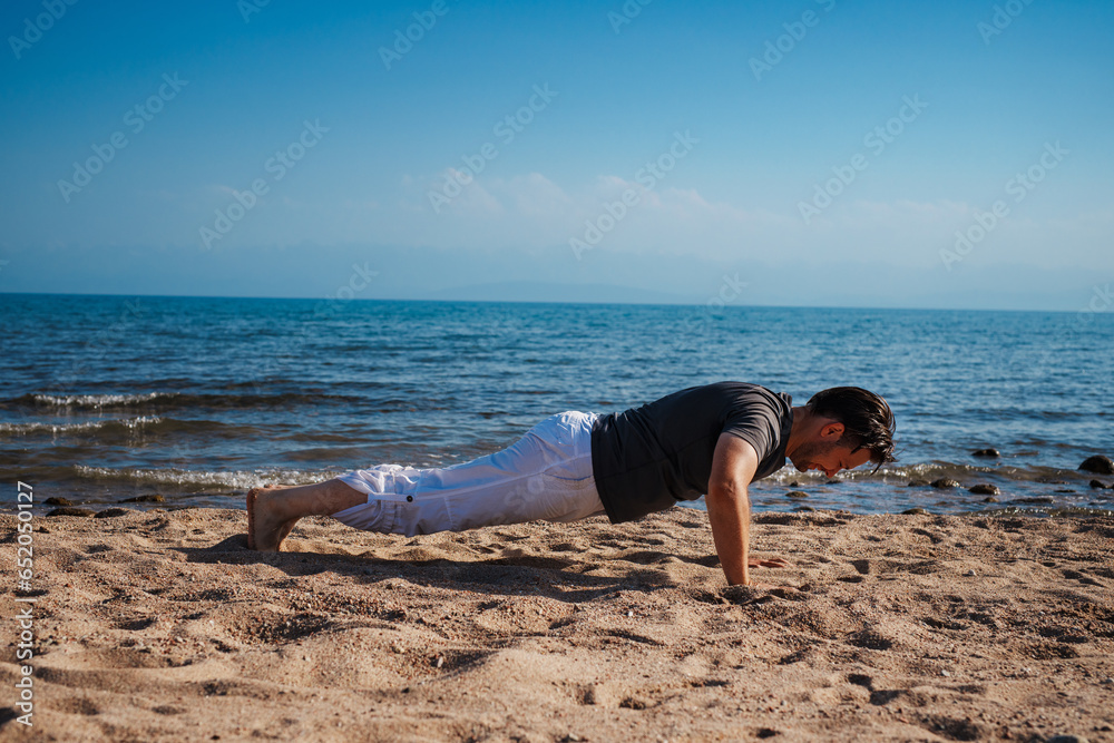 Canvas Prints Sports young man doing push-ups on the beach