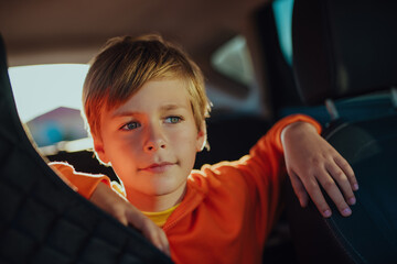 Portrait of handsome boy in automobile at sunset light - 652050768