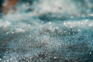 Abstract water in mountain river with water bubbles, close-up view