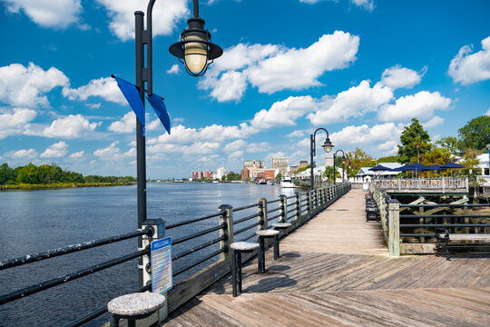 Wooden embankment along the River, Blue sky, snow-white clouds. Wilmington, NC