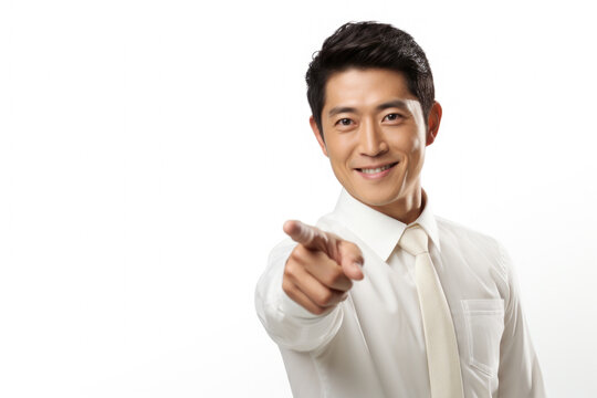 Professional man wearing white shirt and tie is pointing directly at camera. This image can be used to convey confidence, professionalism, or for business-related concepts.
