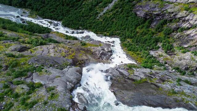 Drone flight over a waterfall in a valley. Glacier water. 