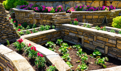 Landscaping with retaining walls and flowerbeds in house backyard