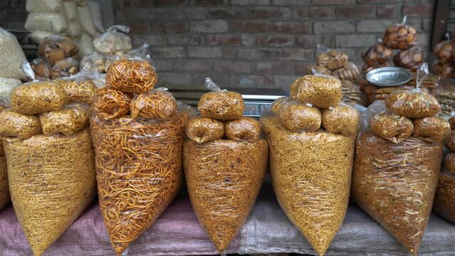 Snacks items at village market in India. Indian snacks are known for their unique flavors and aromas, and this video captures the essence of this culinary tradition.