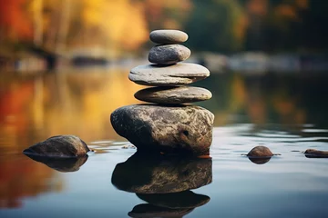 Fototapeten Balancing zen stone pyramid on the shore of a bright autumn forest lake © Маргарита Вайс