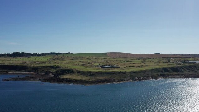 Drone shot of the coastline in Scotland, clear blue skies and vast country side